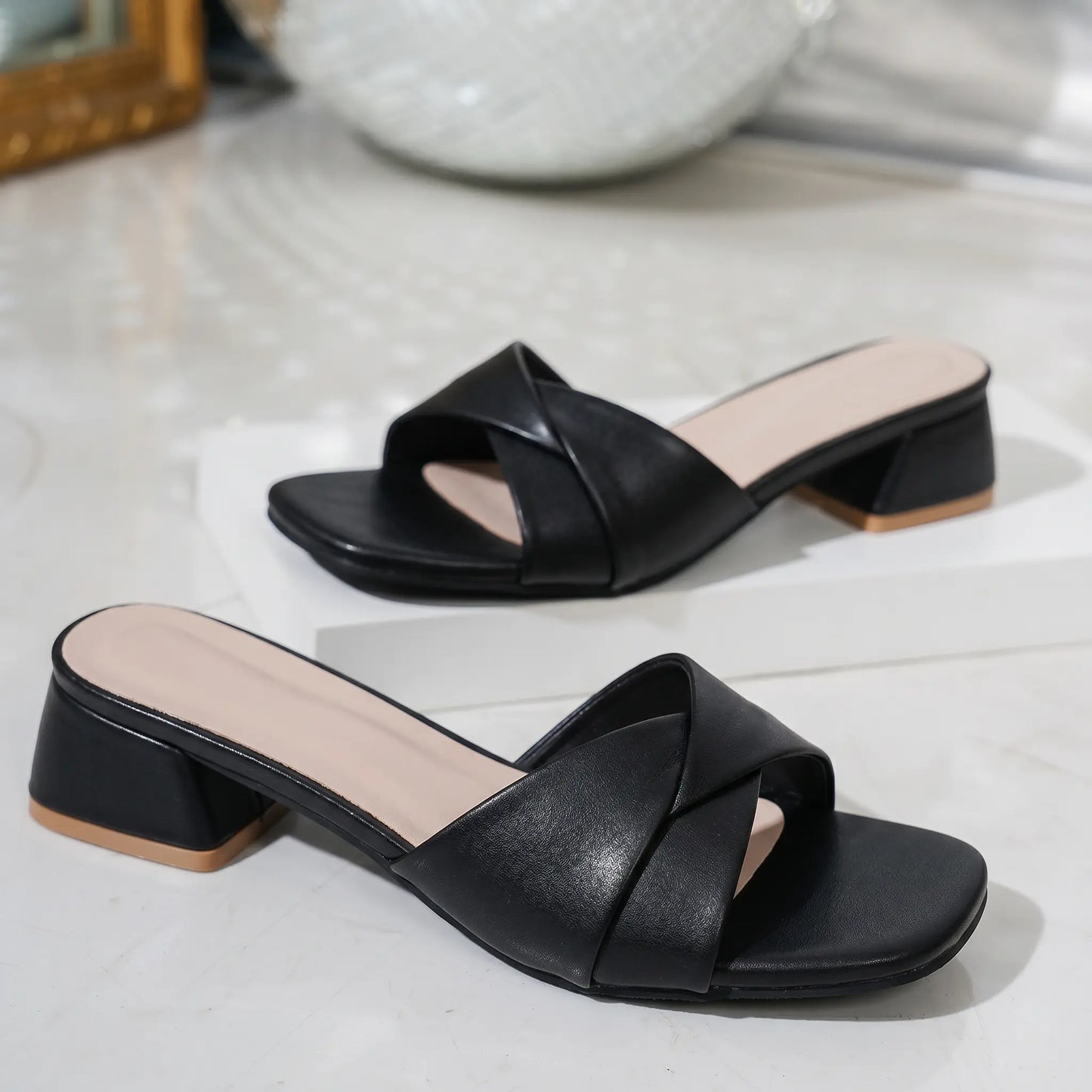 Kaelan Midnight Black PU leather slide sandals featuring a modern square toe, a twisted strap vamp, and a low 4cm block heel with a tan cap.