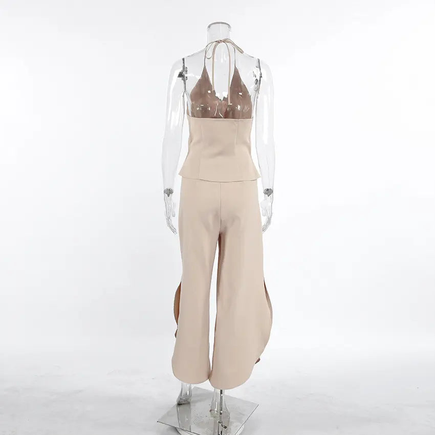 Back view of a Kaelen beige two-piece set featuring a V-neck halter vest and flowing wide-leg palazzo trousers with side splits, displayed on a mannequin against a white background.