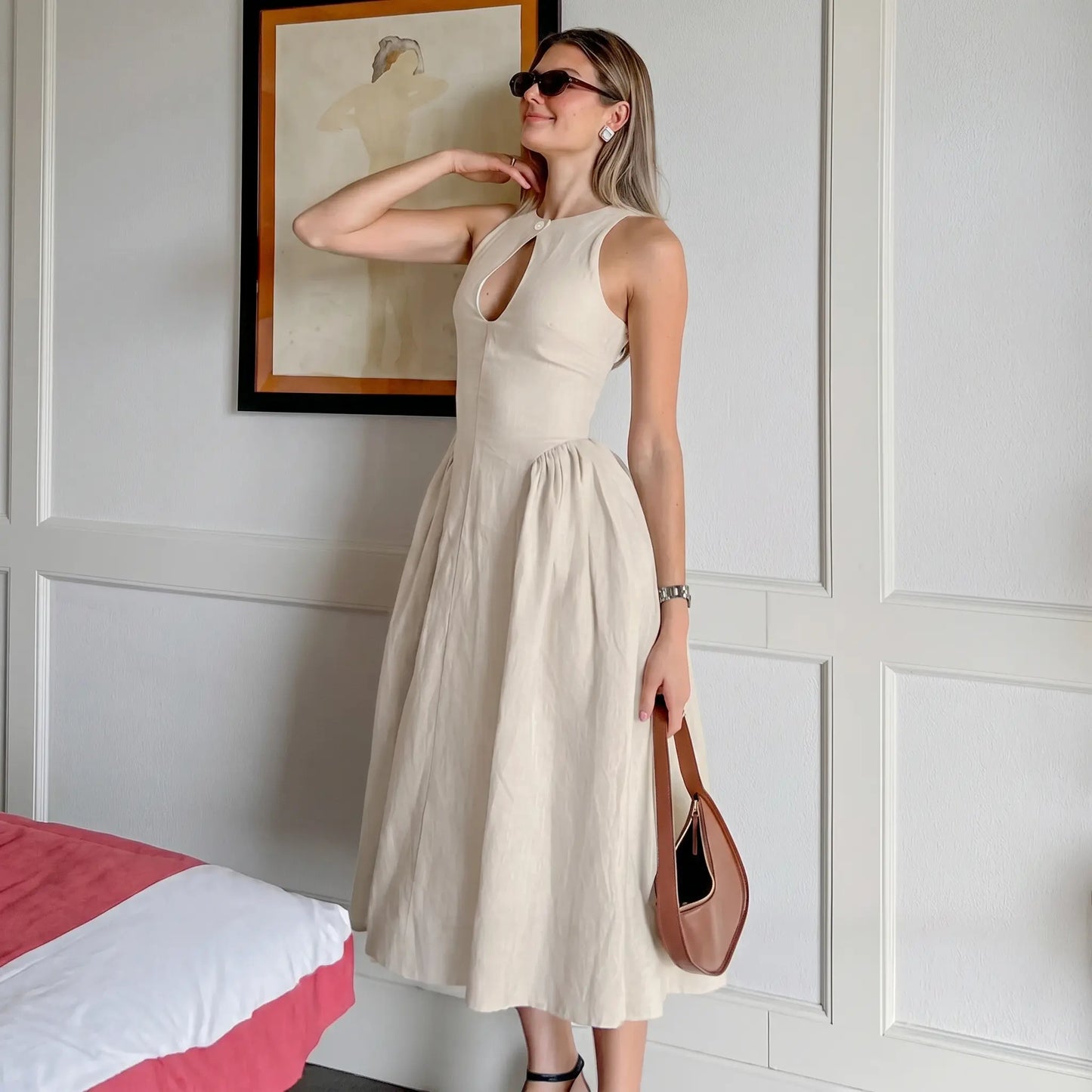 Elegant Kalira linen blend midi dress in natural beige, featuring a sleeveless design, keyhole neckline with button detail, and a flattering gathered A-line skirt worn by a model.