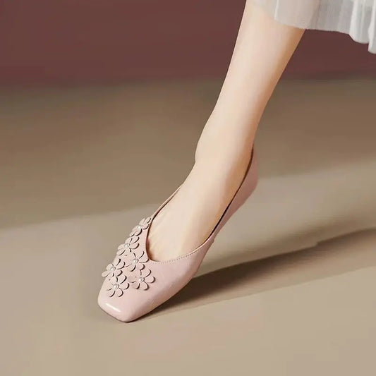 Blush Rose vegan leather square toe flats by Khyzet, adorned with delicate tonal floral appliques and pearl centers, worn on a foot.