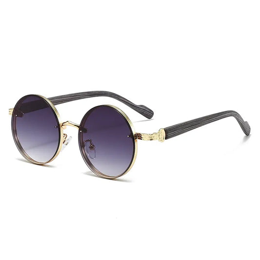 Gold round metal frame sunglasses with dark grey gradient lenses and distinctive wood-grain textured temples, offering UV protection. The glasses are presented from a three-quarter angle on a clean white background.