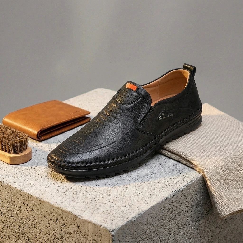 Mokasso men's comfort driving loafer in black vegan leather showing hand-stitched moccasin toe and textured finish in a styled setting.