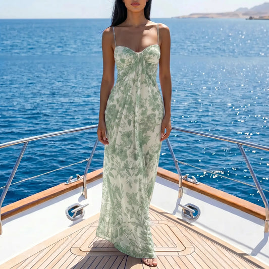 Zenthos Sage Botanical mesh floral maxi dress worn by a model on a yacht, featuring spaghetti straps and a gathered sweetheart bodice.