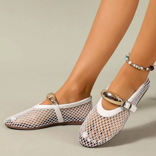 Women's Solarae white mesh flat sandals with decorative gold buckle strap and patent trim, shown on a model's feet with an anklet.