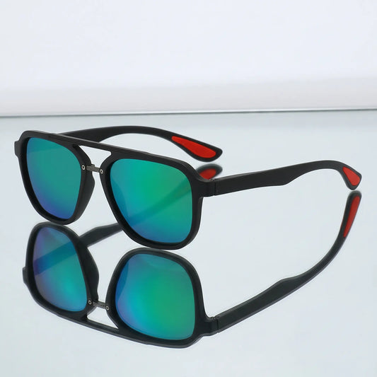 Matte black aviator sunglasses with mirrored blue-green lenses and distinctive red temple tips, shown in a three-quarter view.