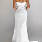 Back view of a white Aelyra halterneck maxi dress made from a textured cotton-linen blend, featuring a concealed zipper and flowing skirt. The thin straps tie at the nape of the neck.