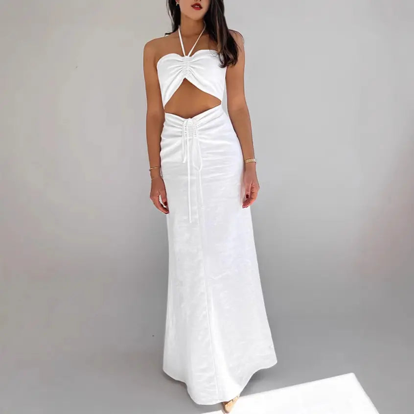 Aelyra white linen blend halterneck maxi dress with ruched bust, midriff cut-out, and drawstring waist, shown on a model from the front.