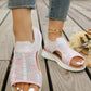 A pair of women's Aeriva pastel mix breathable knit sandals worn on a wooden deck, showcasing their open toe, elasticated heel strap, and layered white sole, paired with distressed denim jeans.
