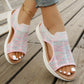 Women's Aeriva pastel multi-color breathable knit sports sandals worn on feet, showcasing open toe, elasticated heel strap, and layered foam sole on a wooden deck.