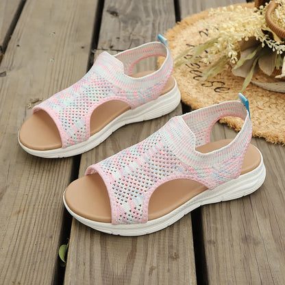 Pair of Aeriva women's pastel multi-color breathable knit sports sandals with an open toe, elasticated heel strap, and a layered white foam sole resting on a wooden deck.
