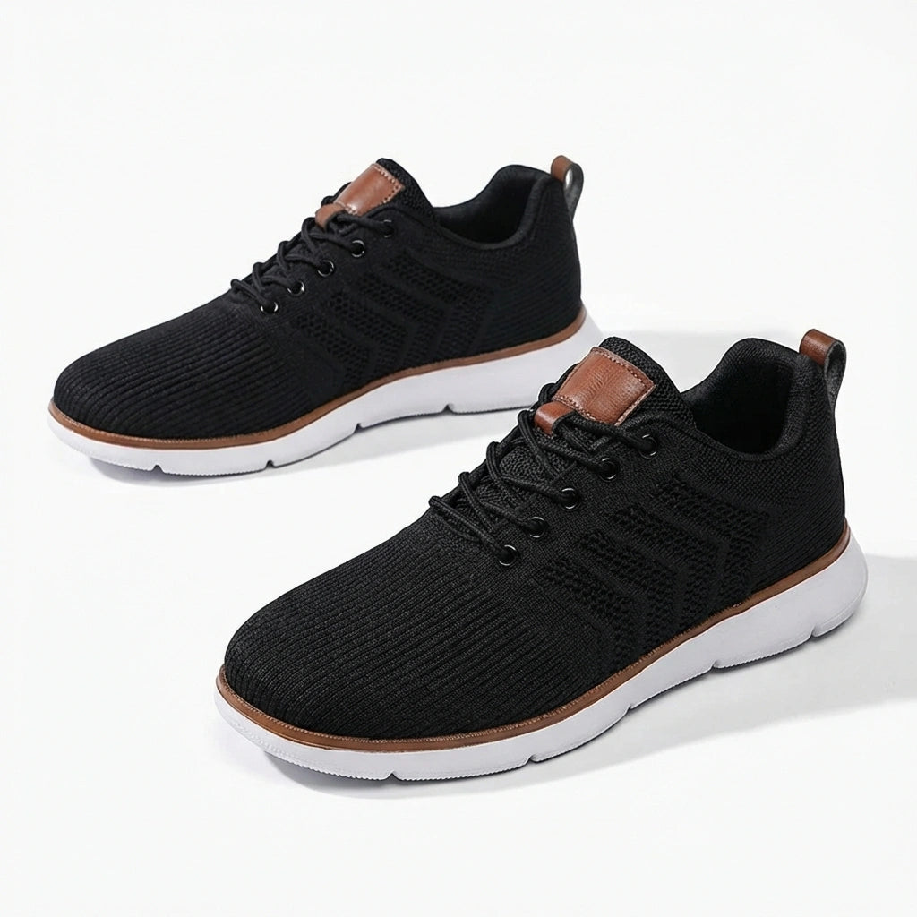 Aerostride Men's Breathable Knit Sneakers in black mesh with brown vegan leather accents — pair view showing the cushioned white sole.