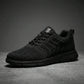 Aerostride men's breathable knit sneakers in Midnight Black mesh — side profile view showing the textured upper and matte cushioned sole.