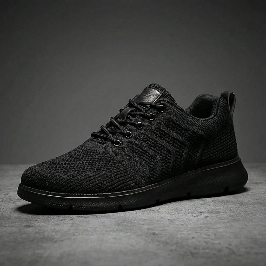 Aerostride men's breathable knit sneakers in Midnight Black mesh — side profile view showing the textured upper and matte cushioned sole.