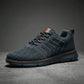 Aerostride Knit Urban Comfort Sneakers in Dark Grey mesh with brown leather accents — side profile view showing the textured upper and cushioned sole.