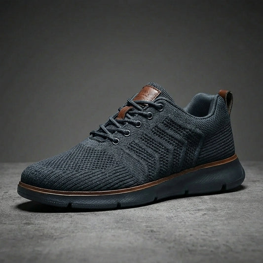 Aerostride Knit Urban Comfort Sneakers in Dark Grey mesh with brown leather accents — side profile view showing the textured upper and cushioned sole.