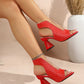 Aethel red peep-toe block heel sandals with woven texture and metallic chain ankle strap, shown on a woman's feet in a lifestyle setting.