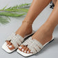 Elegant Aethel white crystal-embellished slide sandals with a square toe, shown on a model's foot with an anklet.