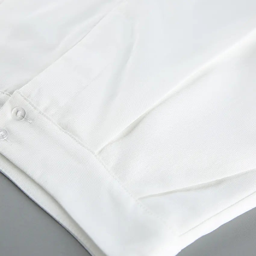 Close-up detail of the premium white viscose blend fabric for Aethel's two-piece set, showcasing stitching and subtle texture.