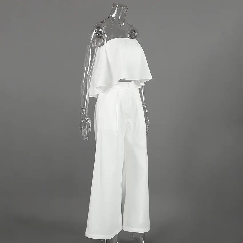 Aethel white strapless ruffled crop top and high-waisted wide-leg trousers set displayed on a mannequin from the side.
