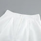 Close-up view of the waistband on off-white wide-leg trousers, showcasing crisp pleats, a single button, and textured fabric detail.