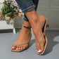 Elegant heeled thong sandals in a sophisticated apricot hue, showcasing a chic square toe and a delicate thong strap on a model's foot, styled with denim. The sculptural mid-height block heel adds a modern touch. A decorative planter with flowers is visible in the background.