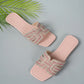 Ayori rhinestone flat slides in blush pink, featuring a chic square toe and a single embellished band strap, displayed from a three-quarter angle with a decorative palm leaf accent.