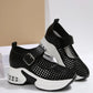 Black women's platform sneakers featuring a breathable mesh upper, adjustable buckle strap, and a translucent air cushion heel detail.