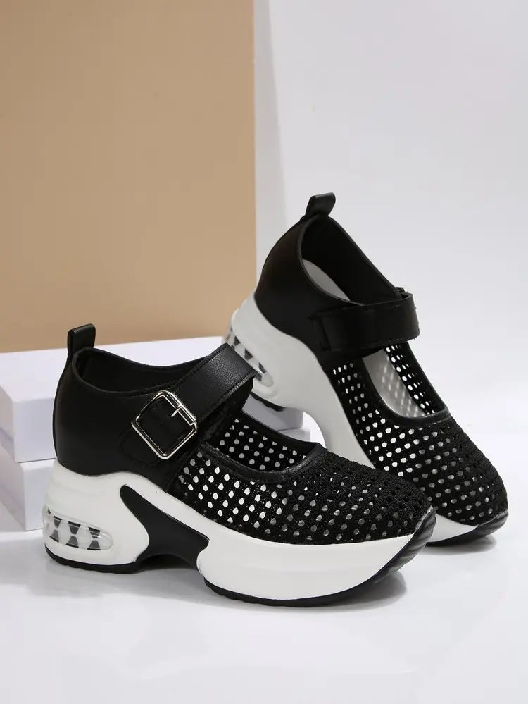 Black women's platform sneakers featuring a breathable mesh upper, adjustable buckle strap, and a translucent air cushion heel detail.