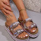 Close-up view of platform slide sandals adorned with intricate bead and sequin embellishments, featuring double adjustable buckle straps and a layered cork-effect sole.