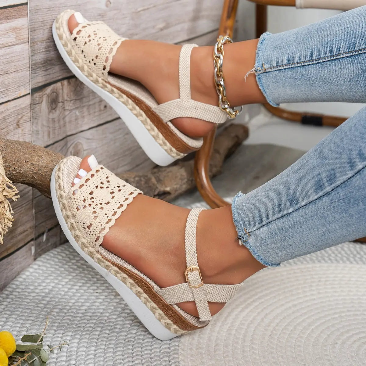 Bohemian beige espadrille wedge sandals with intricate crochet detailing, an adjustable ankle strap, and a jute-wrapped sole, worn with denim.