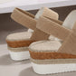 Close-up side view of beige woven fabric espadrille wedge sandals showcasing the natural jute rope wrap on the platform sole and mid-height wedge heel.