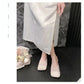 Elegant beige mesh mules with square toe and flat sole, worn by a model in a styled lifestyle setting with subtle floral accents.