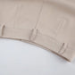 Close-up of warm beige wide-leg palazzo trousers, showcasing the high-waisted design with belt loops and clean stitching.