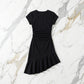 Black premium cotton cap-sleeve dress featuring a crew neck, right-side waist ruching, and an elegant asymmetrical ruffled hem. Laid flat on a white marble background.