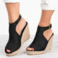 Black espadrille wedge sandals with a peep-toe front, adjustable gold-tone ankle strap, and a natural jute woven sole, shown from a three-quarter angle.