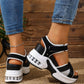 Women's black and grey woven textile platform sandals with a white stacked sole and transparent air cushion heel, shown on feet wearing blue jeans.
