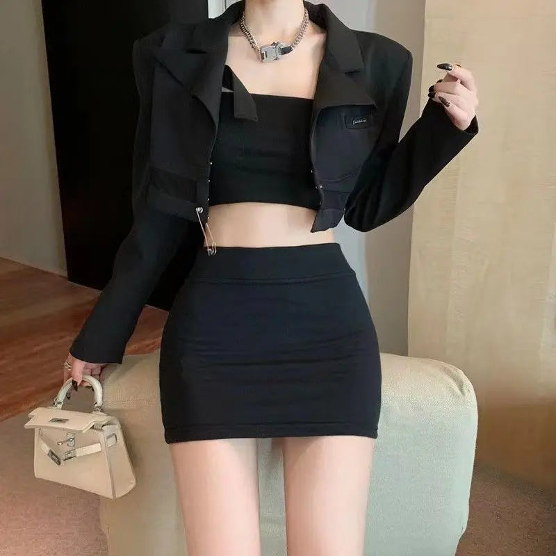 Model wears a black high-waisted bodycon mini skirt with a cropped top and blazer, showcasing its sleek fit and mini length.