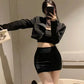 Model showcasing a black high-waisted bodycon mini skirt, featuring a form-fitting silhouette, smooth knit, and wide seamless waistband.