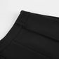Close-up view of black high-waisted tailored shorts, showcasing the structured waistband, crisp front pleats, and a discreet side zipper closure detail. A refined shot highlighting the garment's construction.