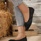 Elegant black knit flat shoes with a pointed toe and a delicate bow accent, shown on a woman's feet paired with distressed denim.