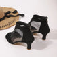 Rear three-quarter view of elegant black suede-like peep-toe ankle boots with sheer mesh side panels and a silver-tone back zipper.