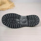 Close-up view of the chunky black rubber lug sole of a platform loafer, showcasing its deep tread pattern and durable construction.