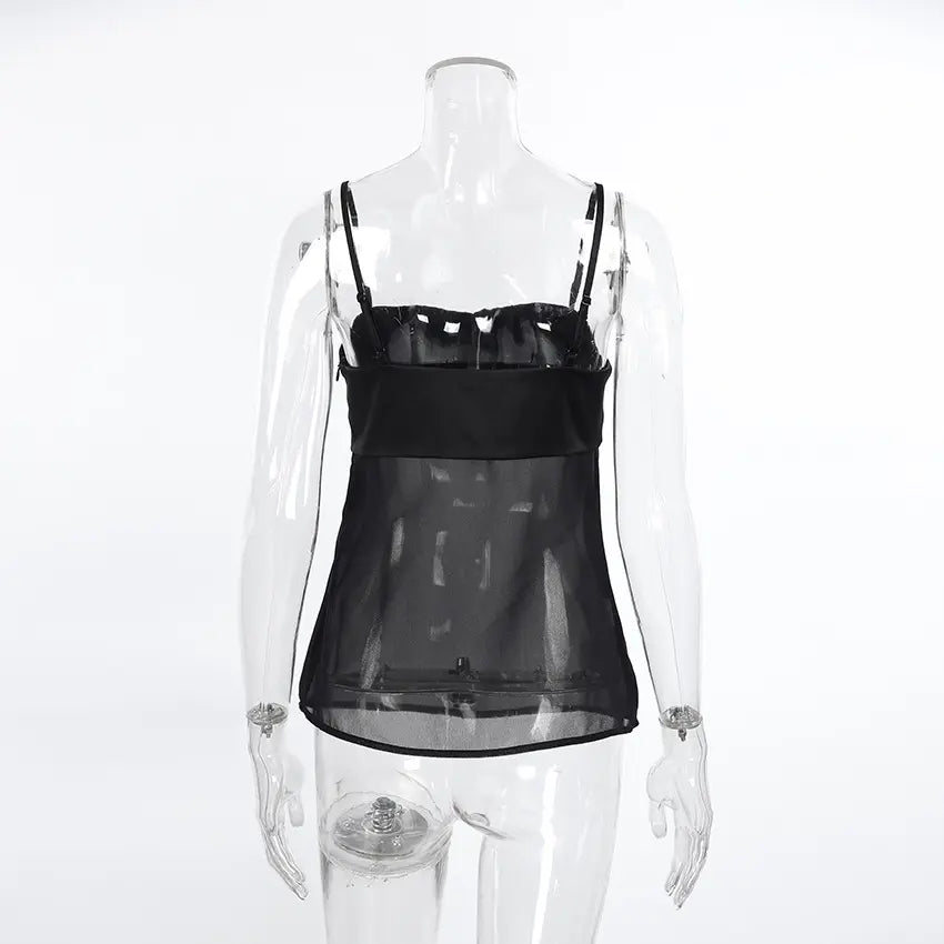 Black sheer camisole top featuring a ruched opaque satin-like bust and a delicate lower panel with thin adjustable spaghetti straps.