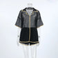 Black sheer mesh lounge set with gold contrast piping, featuring a camp collar button-down shirt and drawstring shorts, displayed on a mannequin against a white background.