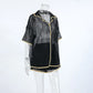 Black sheer mesh lounge set featuring a short-sleeved camp collar shirt and drawstring shorts, detailed with gold contrast piping, displayed on a mannequin against a white studio background.