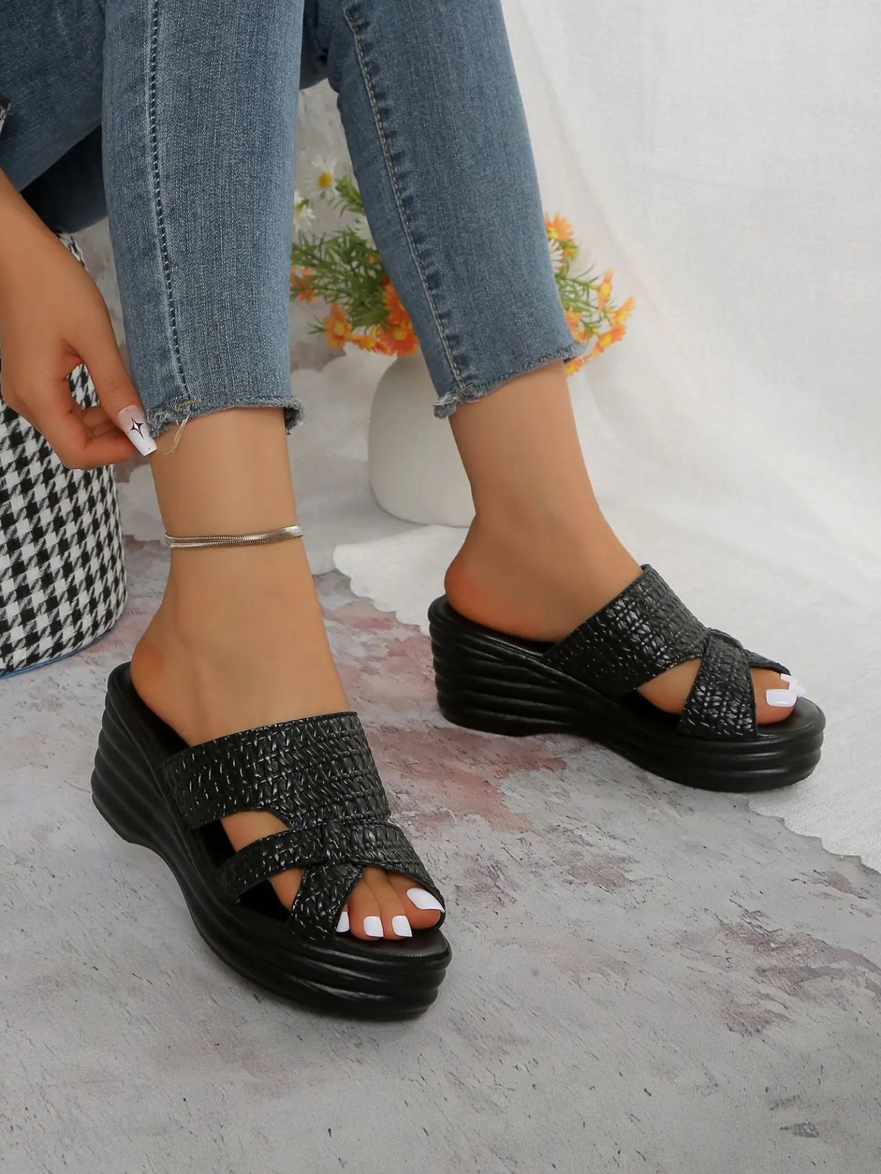 Nexaera women's black woven PU platform wedge sandals styled with blue denim jeans, showcasing the peep-toe design and high wedge heel.