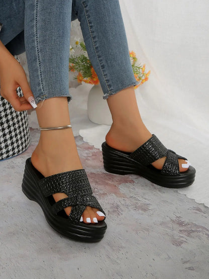 Nexaera women's black woven PU platform wedge sandals styled with blue denim jeans, showcasing the peep-toe design and high wedge heel.