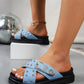 Women's light blue denim-look platform slide sandals adorned with silver studs and an ornate silver buckle, shown on a model's foot with an open toe and thick sole.