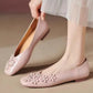Elegant Blush Rose floral square-toe flats with intricate tonal appliques and pearl centers, worn on a foot with a hand adjusting a second shoe.