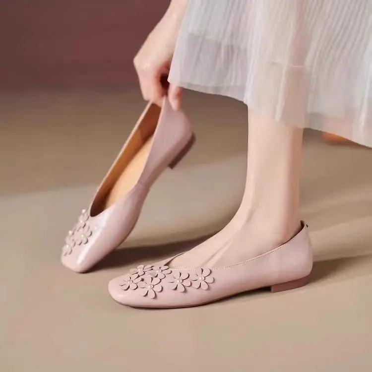 Blush Rose vegan leather square toe flats with tonal floral appliques and pearl centers, worn by a woman, showcasing the elegant slip-on style.